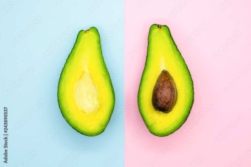 Avocado half on blue and pink background minimal food Avocado half on blue and pink background minimal food