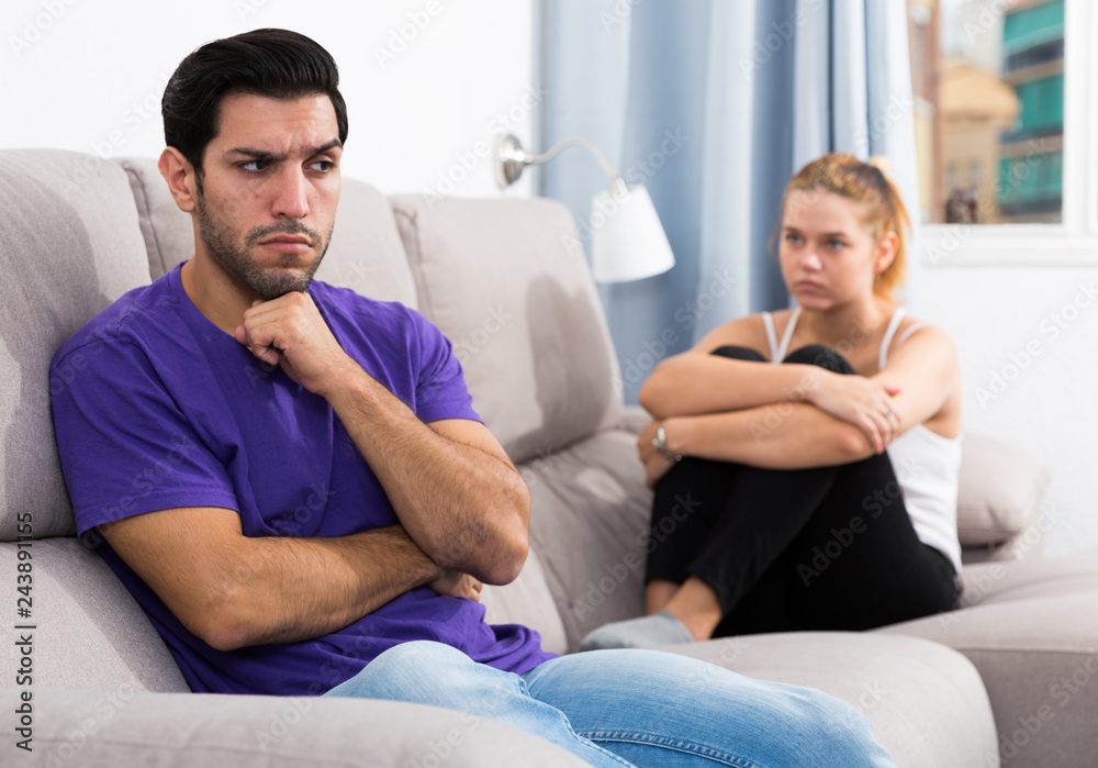 Fototapeta premium Guy on couch after discord with girlfriend