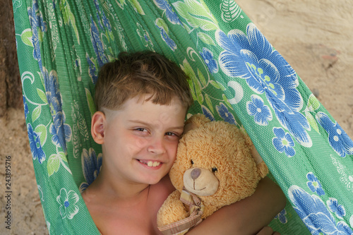 8 years old little boy with teddy bear photo