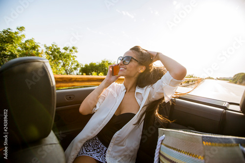 Woman uses mobile phone and...