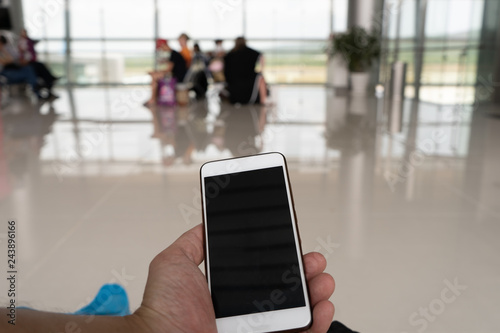 Wallpaper Mural woman working on phone in departure terminal Torontodigital.ca