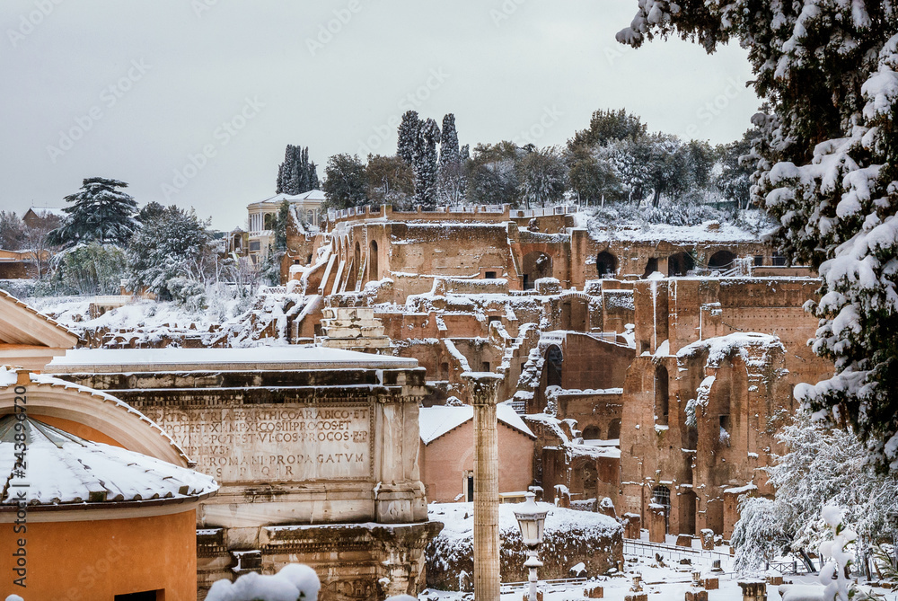 View of Roman Forum and Palatine ancient ruins covered with snow from Capitoline Hill in Rome View of Roman Forum and Palatine ancient ruins covered with snow from Capitoline Hill in Rome