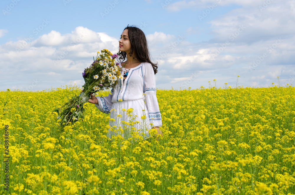 Fototapeta premium little girl in the flowers field