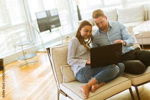 Couple using laptop in the ...