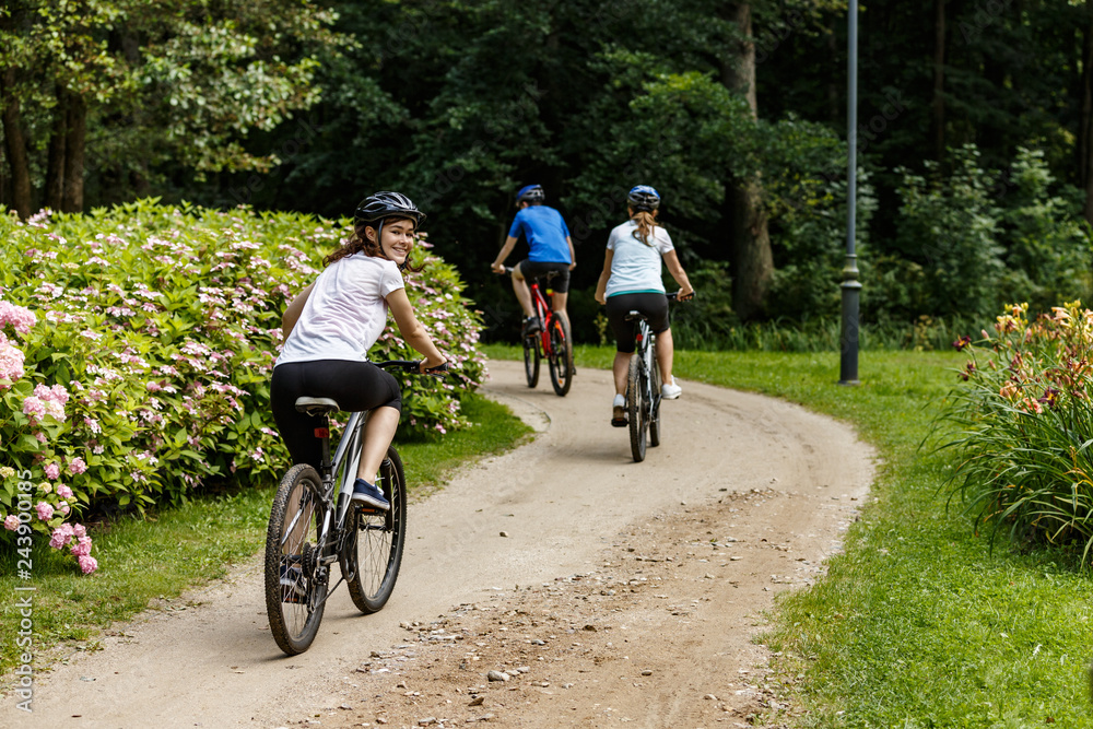 Healthy lifestyle - people riding bicycles in city park Healthy lifestyle - people riding bicycles in city park