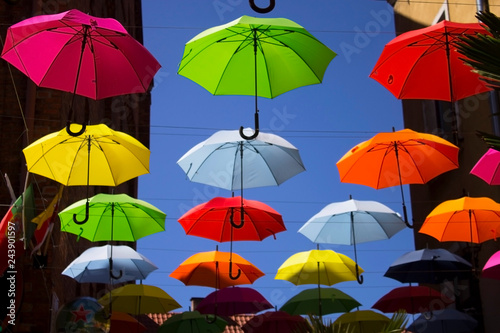 colored umbrellas hanging against the sky
