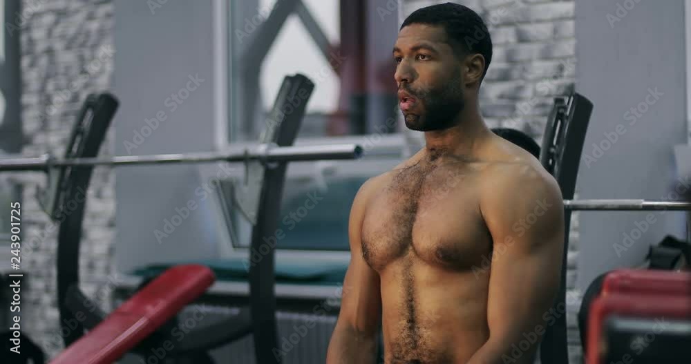 A young black man with muscles is preparing for training. A young black man with muscles is preparing for training.