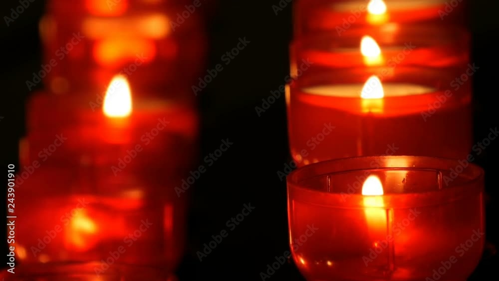 Burning red round candles in catholic church Burning red round candles in catholic church