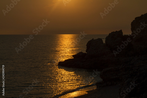 Orange sunset and rocky beach in Drymades Dhermi Albania