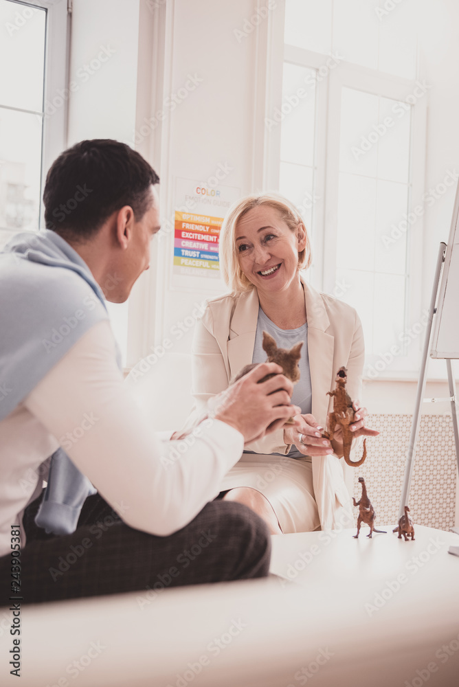 Naklejka premium Pleased blonde woman having friendly talk with patient