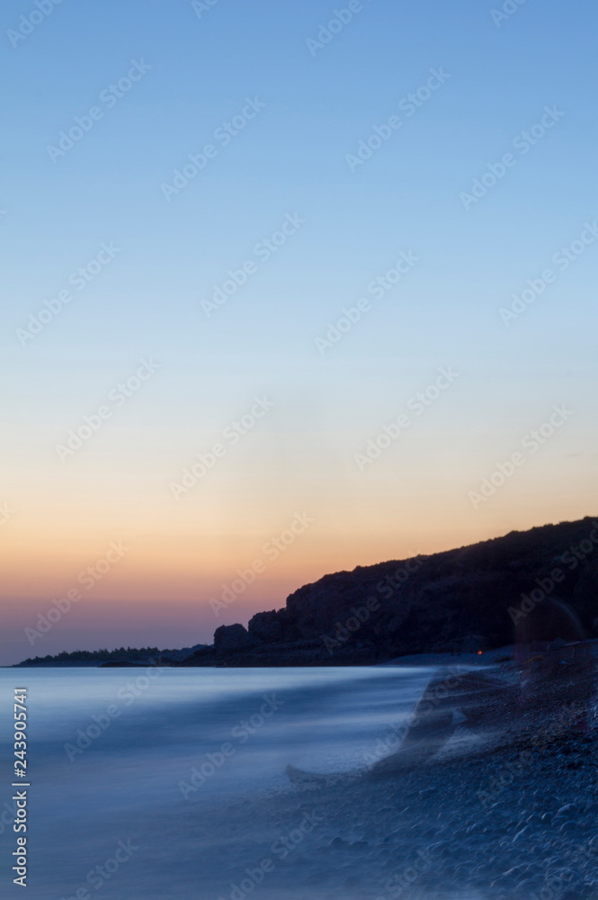 Obraz premium Long exposure sunset shot in portrait mode of Drymades beach Dhermi Albania
