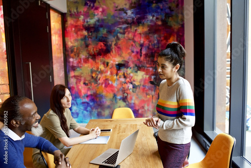 Female Asian creative professional presenting work to a client