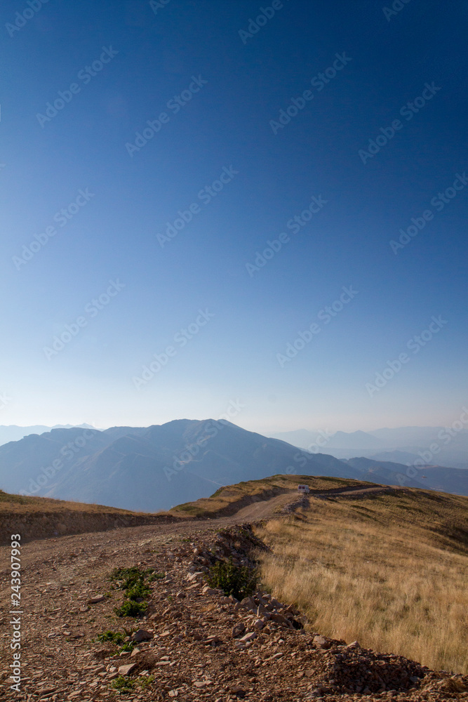 Atop the mountain Tomorr in Albania overlooking road in portrait mode Atop the mountain Tomorr in Albania overlooking road in portrait mode