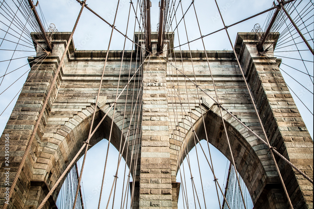 Fototapeta premium Brooklyn Bridge pylon structure made out of bricks during summer sunny day