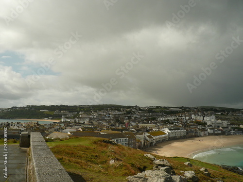 Saint Ives Porthmeor beach sand and see against a heavy play of clouds photo