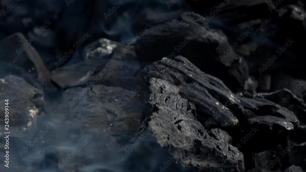 4K. Close-up of charcoal burning. Smoke and flames. Hot coal and flame in the barbecue grill. 4K. Close-up of charcoal burning. Smoke and flames. Hot coal and flame in the barbecue grill.