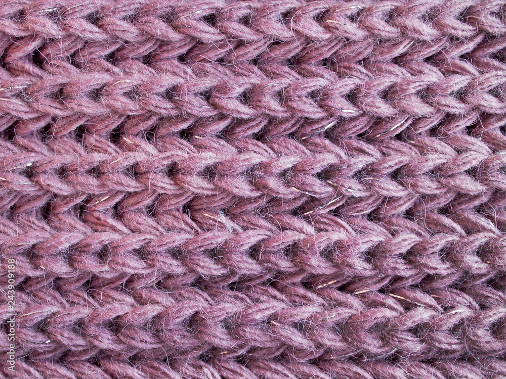 Knitted fabric. Large handmade knitting of lilac yarn. For textures, backgrounds.