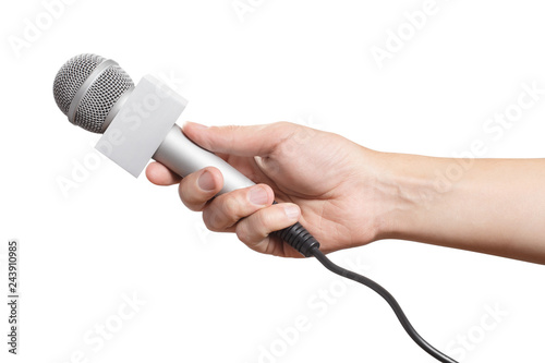 Male hand holding a microphone, isolated on white background photo