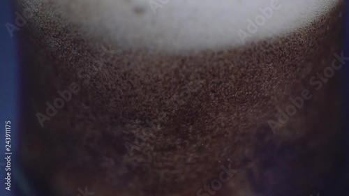 Slow Motion shot of beer being poured and splashing into a glass. Glamour shots of beer being poured