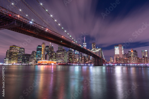 View on Financial district with Brooklyn bridge from east river at night with long exposure © Andriy Stefanyshyn