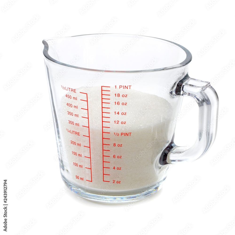 Granulated sugar in measuring cup isolated on white background Stock Photo  | Adobe Stock