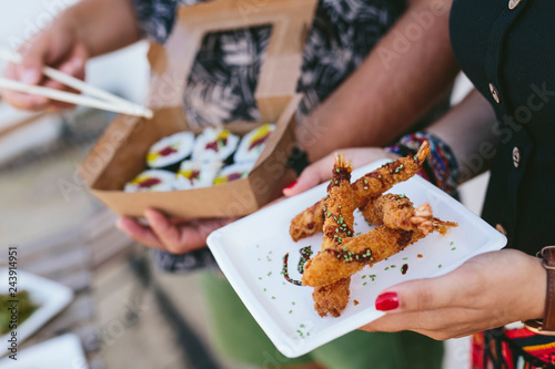 Crop people with delicious street food