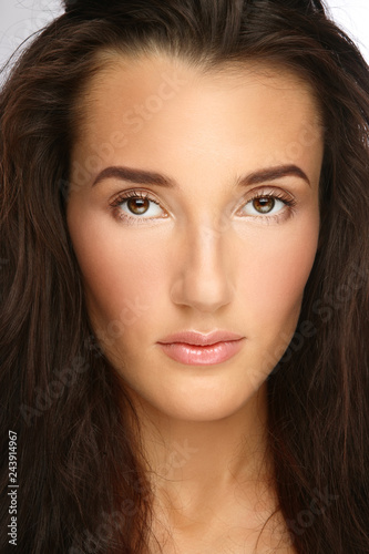 Close-up portrait of young beautiful woman with clear make-up