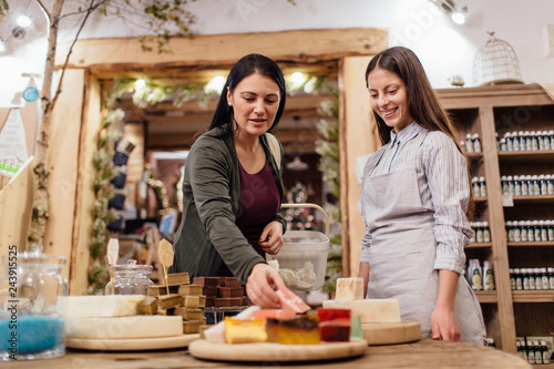 Young woman choosing natural homemade soap at package free store.