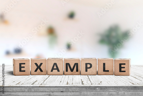 Tablou pe pânză Example sign on a wooden table in a bright room