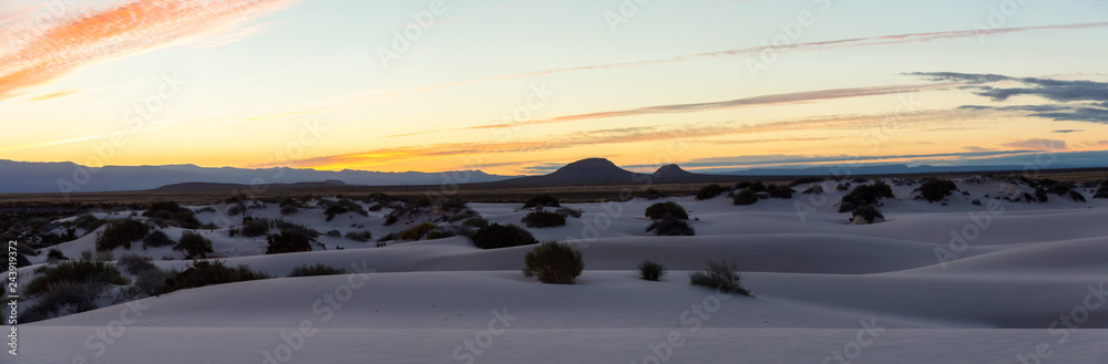 Beautiful panoramic view of white sand during a colorful sunrise. Taken in White Sands National Monument, New Mexico, United States.