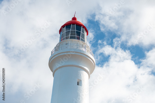 White and red lighthouse in blue sky