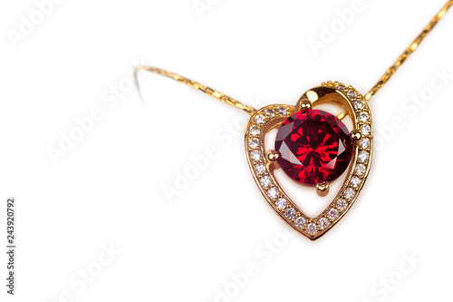 Gold heart pendant with precious stones on white background isolated