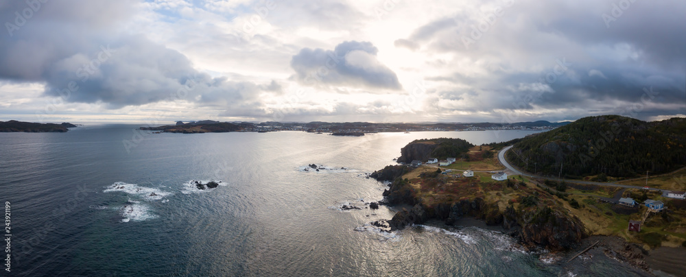 Aerial view of a small town on a rocky Atlantic Ocean Coast during a cloudy day. Taken in Paradise, Twillingate, Newfoundland, Canada. Aerial view of a small town on a rocky Atlantic Ocean Coast during a cloudy day. Taken in Paradise, Twillingate, Newfoundland, Canada.