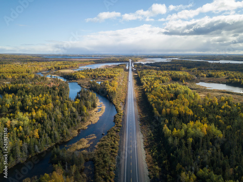 Aerial view of a scenic road during a beautiful sunny day in the Autumn. Taken near Grand Falls-Windsor, Newfoundland, Canada.