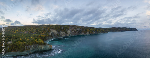 Aerial panoramic Canadian Landscape View by the Atlantic Ocean Coast during a cloudy sunrise. Taken in Beachside, Newfoundland, Canada.