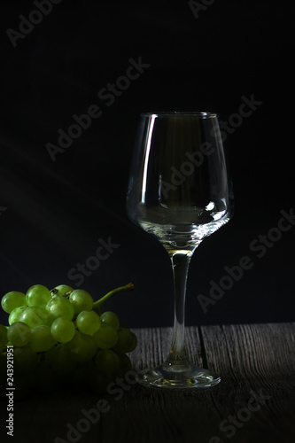 Wineglasses with grapes and corks on dark background with copy space 