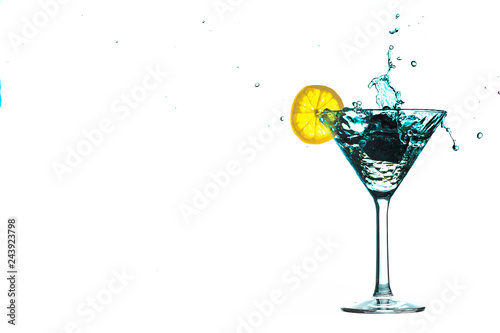Blue cocktail water drink splash in the glass with lemon Isolated on white