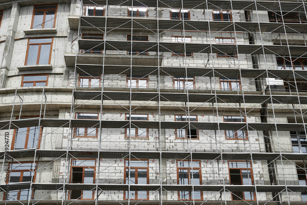 new building under construction, scaffolding and concrete