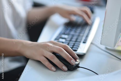 Women's hands on the keyboard