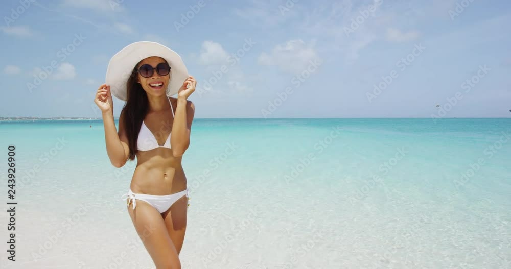Happy Asian American girl having fun beach on luxury island under the sun. Shot on RED EPIC. Happy Asian American girl having fun beach on luxury island under the sun. Shot on RED EPIC.