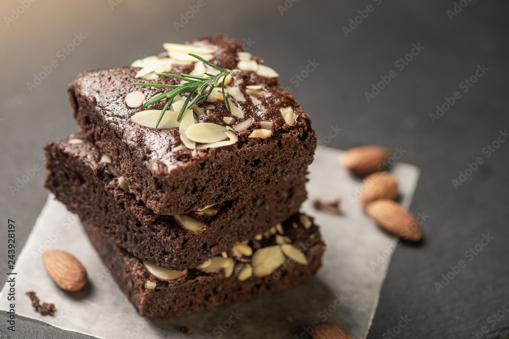 A stack of chocolate brownies on dark plat background ,homemade bakery and dessert. A stack of chocolate brownies on dark plat background ,homemade bakery and dessert.