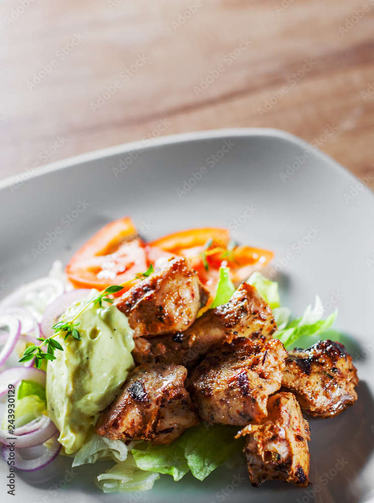 fried chicken breast piece fillet with vegetables salad on white plate