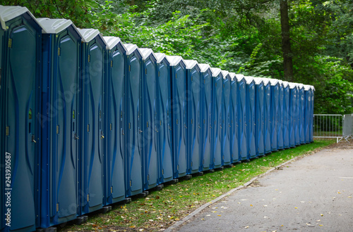 Bio public wc at a park. Locked, portable chemical lavatories. Nature background.