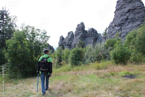 Tourist traveler in the forest on the road.