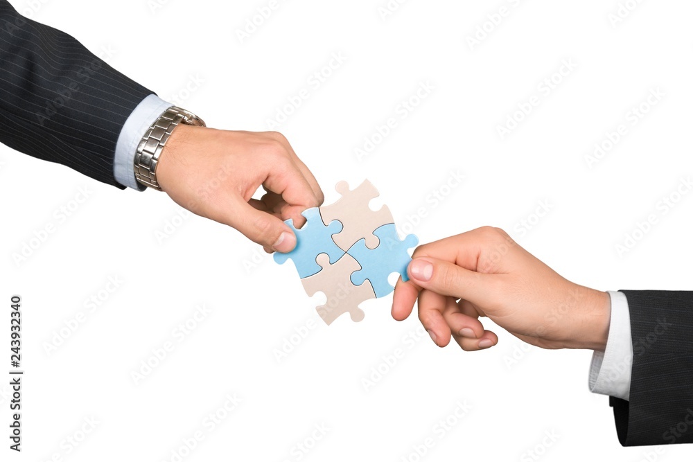 Closeup on Businesspeople Combining Puzzle Pieces Together Closeup on Businesspeople Combining Puzzle Pieces Together