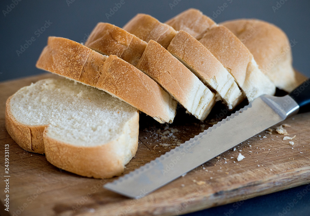fresh cut bread is shown on a cutting board with a bread knife