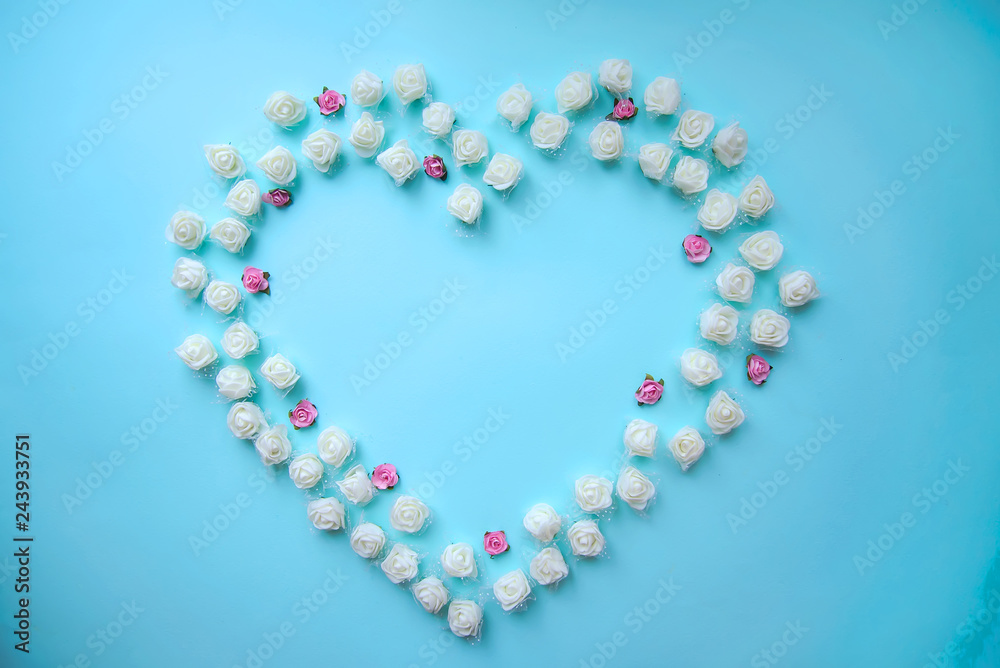 White and pink heart shaped roses on blue background