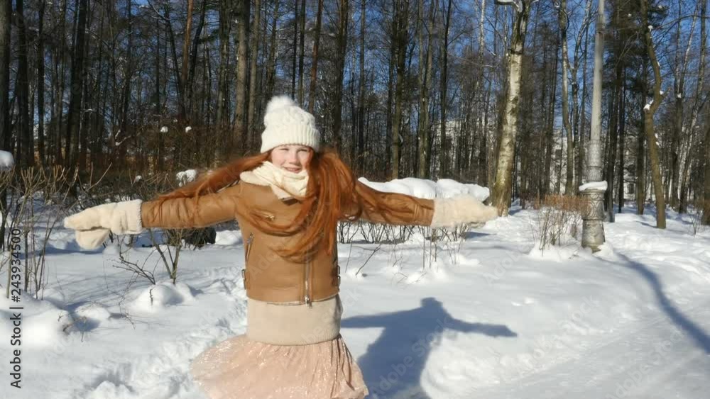 Redhead teenage girl, child having fun on winter walk. Happy teen girl spinning in winter park vídeo de Stock | Adobe Stock