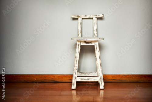 White Wooden Stool Against Wall