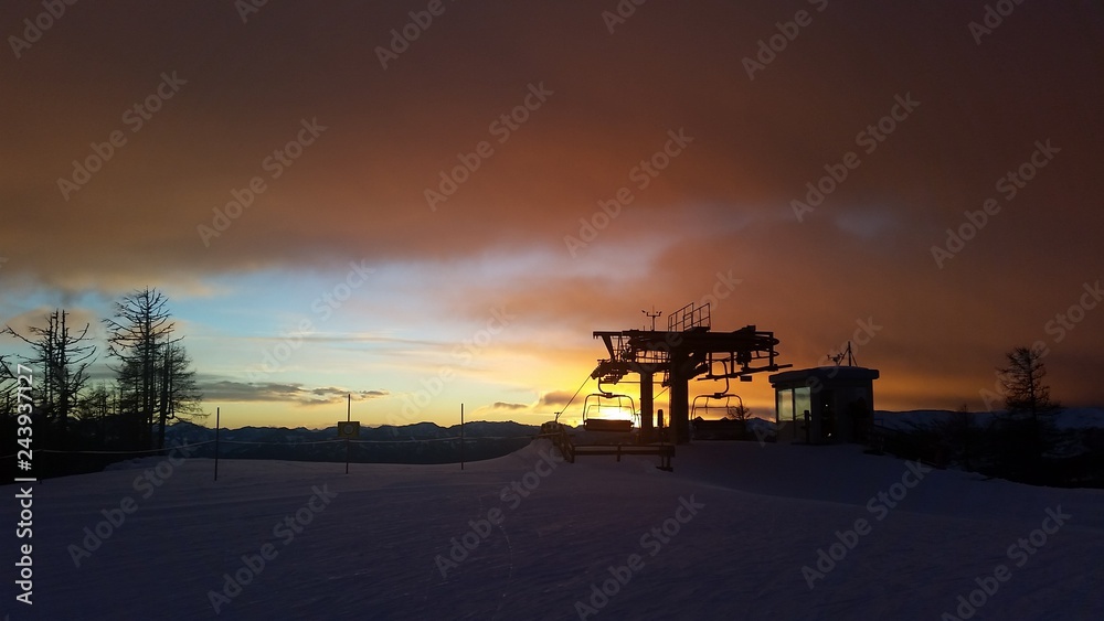 St. Oswald, Austria, Carinthia - December 9, 2018: Captured the silhouette of a lift station on the top of a mountain in St. Oswald, Austria, Carinthia, in the sunset.during a hiking.
